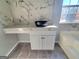 Bathroom features a stylish bowl sink, gray tile floor, and modern marble wall design at 4284 Caroline Ct, Douglasville, GA 30135