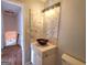 Bathroom features marble tiled walls and vanity with unique copper bowl sink at 4284 Caroline Ct, Douglasville, GA 30135