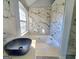 The bathroom boasts a luxurious tub, sleek bowl sink, and elegant marble wall accents at 4284 Caroline Ct, Douglasville, GA 30135