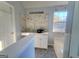 Bathroom features a marble tiled vanity, gray tiled floor, and natural light at 4284 Caroline Ct, Douglasville, GA 30135