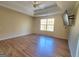 Spacious bedroom featuring a tray ceiling, ceiling fan, and hardwood floors at 4284 Caroline Ct, Douglasville, GA 30135
