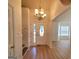 Bright foyer with gleaming hardwood floors, chandelier, and a view into the adjacent living spaces at 4284 Caroline Ct, Douglasville, GA 30135