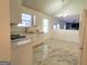 Open kitchen with quartz countertops, white cabinets, stainless appliances, and marble flooring at 4284 Caroline Ct, Douglasville, GA 30135