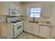 Clean kitchen featuring white cabinetry, quartz countertops, modern appliances, and ample lighting at 4284 Caroline Ct, Douglasville, GA 30135