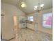 Bright kitchen with white cabinetry, marble floors, and stainless steel appliances, perfect for cooking and entertaining at 4284 Caroline Ct, Douglasville, GA 30135