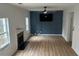Spacious living room with an electric fireplace, natural light, and accent wall for TV at 4284 Caroline Ct, Douglasville, GA 30135