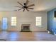 Spacious living room with fireplace, natural light, and modern ceiling fan at 4284 Caroline Ct, Douglasville, GA 30135
