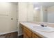 Bathroom with a wood vanity, bright lighting, and neutral design at 167 London Dr, Mcdonough, GA 30253
