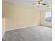 Spacious bedroom featuring neutral walls, plush carpet, and a ceiling fan for added comfort at 167 London Dr, Mcdonough, GA 30253