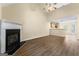 Bright living space boasting hardwood floors, fireplace, and adjacent kitchen area at 167 London Dr, Mcdonough, GA 30253