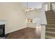 Open-concept living room with hardwood floors, fireplace, and a view into the kitchen at 167 London Dr, Mcdonough, GA 30253