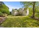 Large backyard featuring well-maintained lawn, mature trees, and multi-level decks at 85 Bloomfield Way, Sharpsburg, GA 30277