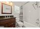 Bathroom featuring a shower-tub combo with striped curtain, a dark vanity and a mirror at 85 Bloomfield Way, Sharpsburg, GA 30277