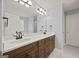 Bathroom featuring a double vanity with dark wood cabinets and a white countertop at 85 Bloomfield Way, Sharpsburg, GA 30277