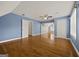 Spacious bedroom with hardwood floors, blue walls, and a walk-in closet providing ample space for rest and storage at 85 Bloomfield Way, Sharpsburg, GA 30277