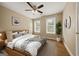 Comfortable bedroom with a large bed, ceiling fan, and natural light, creating a relaxing retreat at 85 Bloomfield Way, Sharpsburg, GA 30277