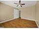 Bright bedroom with hardwood floors, a ceiling fan, and ample closet space, offering a versatile layout at 85 Bloomfield Way, Sharpsburg, GA 30277