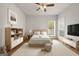 Bright bedroom with a ceiling fan, large windows, a queen bed and matching bedside cabinets at 85 Bloomfield Way, Sharpsburg, GA 30277