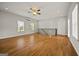 An expansive bonus room featuring hardwood floors, bright natural light, and access to the staircase at 85 Bloomfield Way, Sharpsburg, GA 30277