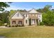 Charming two-story home boasts a manicured lawn and inviting brick and vinyl facade, creating a welcoming curb appeal at 85 Bloomfield Way, Sharpsburg, GA 30277