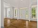 The bright foyer has hardwood floors and large windows at 85 Bloomfield Way, Sharpsburg, GA 30277