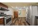 A bright kitchen featuring stainless steel appliances and hardwood floors at 85 Bloomfield Way, Sharpsburg, GA 30277