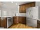 This kitchen features wooden cabinets, stainless steel appliances, a white countertop, and a subway tile backsplash at 85 Bloomfield Way, Sharpsburg, GA 30277