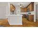 This kitchen features wooden cabinets, stainless steel appliances, a white countertop, and an island at 85 Bloomfield Way, Sharpsburg, GA 30277