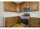 A kitchen featuring wooden cabinets, stainless steel appliances, white countertops, and a white subway tile backsplash at 85 Bloomfield Way, Sharpsburg, GA 30277
