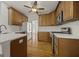 This kitchen features stainless steel appliances, wooden cabinets, and stylish countertops at 85 Bloomfield Way, Sharpsburg, GA 30277