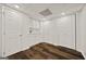 Laundry room area with hardwood floors, sink and storage at 85 Bloomfield Way, Sharpsburg, GA 30277