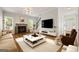 Bright living room boasts a fireplace, hardwood floors, large windows, and neutral decor at 85 Bloomfield Way, Sharpsburg, GA 30277