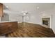 Bright living room featuring hardwood floors, a ceiling fan, and a stone fireplace at 85 Bloomfield Way, Sharpsburg, GA 30277