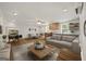 Open-concept living room with hardwood floors, neutral decor, and abundant natural light, perfect for entertaining at 85 Bloomfield Way, Sharpsburg, GA 30277