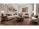 The cozy living room features neutral decor, plush seating, and elegant artwork at 85 Bloomfield Way, Sharpsburg, GA 30277