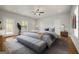Spacious bedroom featuring a large bed, bench, ceiling fan, and ample natural light at 85 Bloomfield Way, Sharpsburg, GA 30277