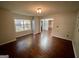 Bright living room features hardwood floors, a large window, and neutral paint, creating a welcoming space at 1529 Evergreen Hollow Ln, Conyers, GA 30012