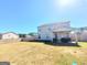 Large backyard with a covered patio, wood fence, and plenty of green space at 116 Jodi Pl, Locust Grove, GA 30248