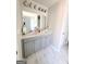 Bathroom with a double vanity, modern fixtures, and elegant tile flooring at 116 Jodi Pl, Locust Grove, GA 30248