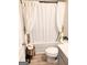 Cozy bathroom featuring a shower with a white curtain and light gray cabinets at 116 Jodi Pl, Locust Grove, GA 30248