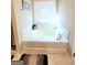 Inviting soaking tub with a marble surround and natural light at 116 Jodi Pl, Locust Grove, GA 30248