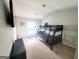 Cozy bedroom featuring a bunk bed, neutral walls, and carpet flooring at 116 Jodi Pl, Locust Grove, GA 30248