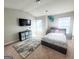 Comfortable bedroom with a plush bed, large rug, and mounted TV at 116 Jodi Pl, Locust Grove, GA 30248