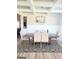 Bright dining room featuring a decorative ceiling, modern chandelier, and seating for six at 116 Jodi Pl, Locust Grove, GA 30248