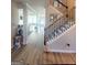 Inviting foyer featuring hardwood floors, staircase, and views of the living spaces at 116 Jodi Pl, Locust Grove, GA 30248