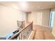 Upstairs hallway featuring wood and iron banisters and several entrances at 116 Jodi Pl, Locust Grove, GA 30248