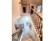 Open hallway with hardwood flooring and staircase with decorative iron spindles at 116 Jodi Pl, Locust Grove, GA 30248