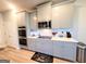 Modern kitchen with stainless steel appliances, sleek gray cabinets, and light countertops at 116 Jodi Pl, Locust Grove, GA 30248