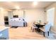 Open-concept kitchen featuring stainless steel appliances, light wood floors and a round table at 116 Jodi Pl, Locust Grove, GA 30248