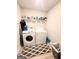 Laundry room with modern washer and dryer, plus ample shelving and storage at 116 Jodi Pl, Locust Grove, GA 30248